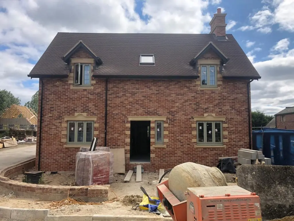 New build detached house under construction by builders in Oxford